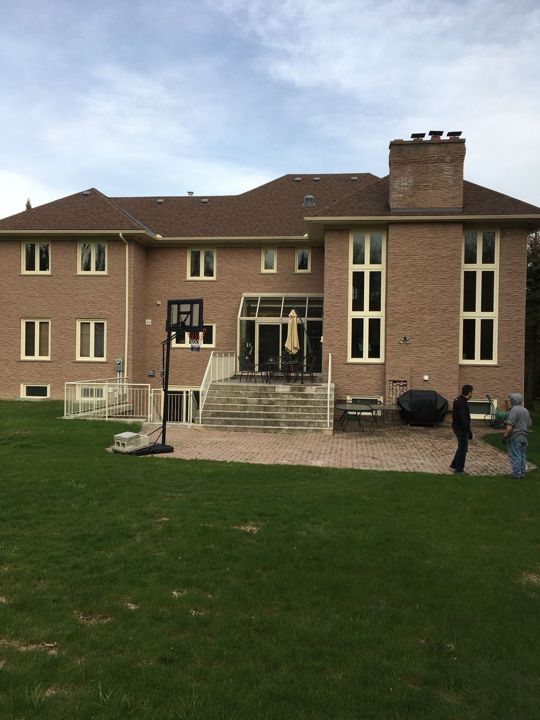 Rear of a large brick house with eavestrough and downspout